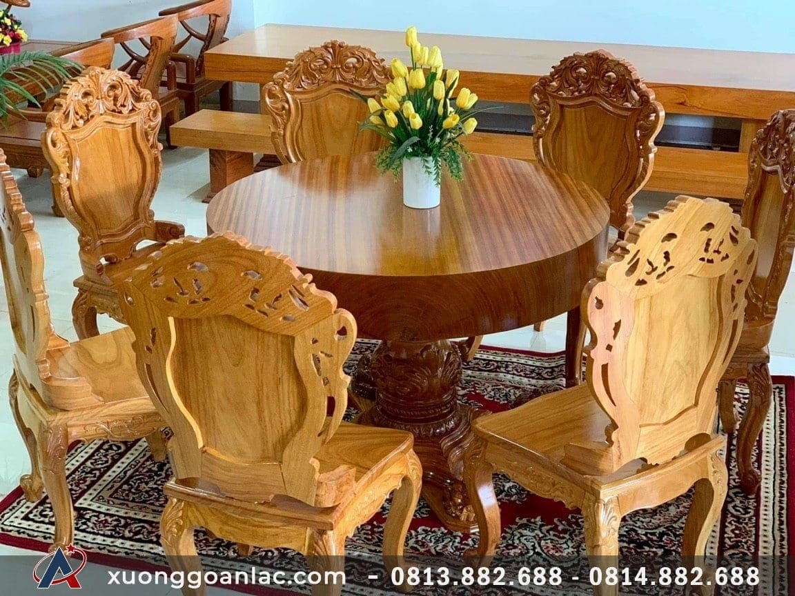Bộ bàn ăn tròn nguyên khối gỗ gõ đỏ 7 ghế đục hoa lá tây (Anh Sơn, Hà Nội)